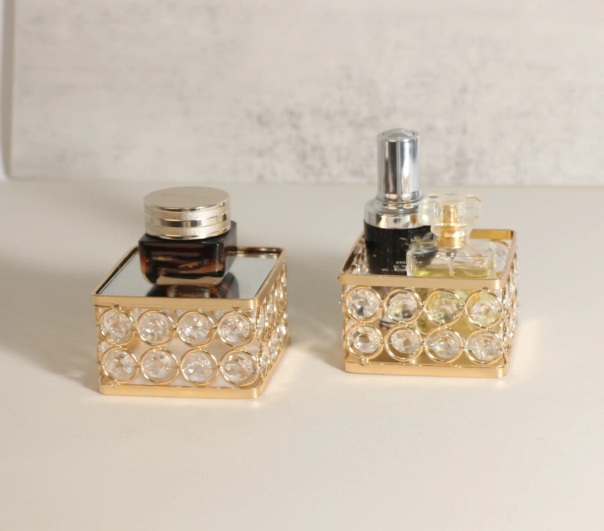 Display Pedestal with cosmetics arranged on its mirrored platform for a refined vanity display