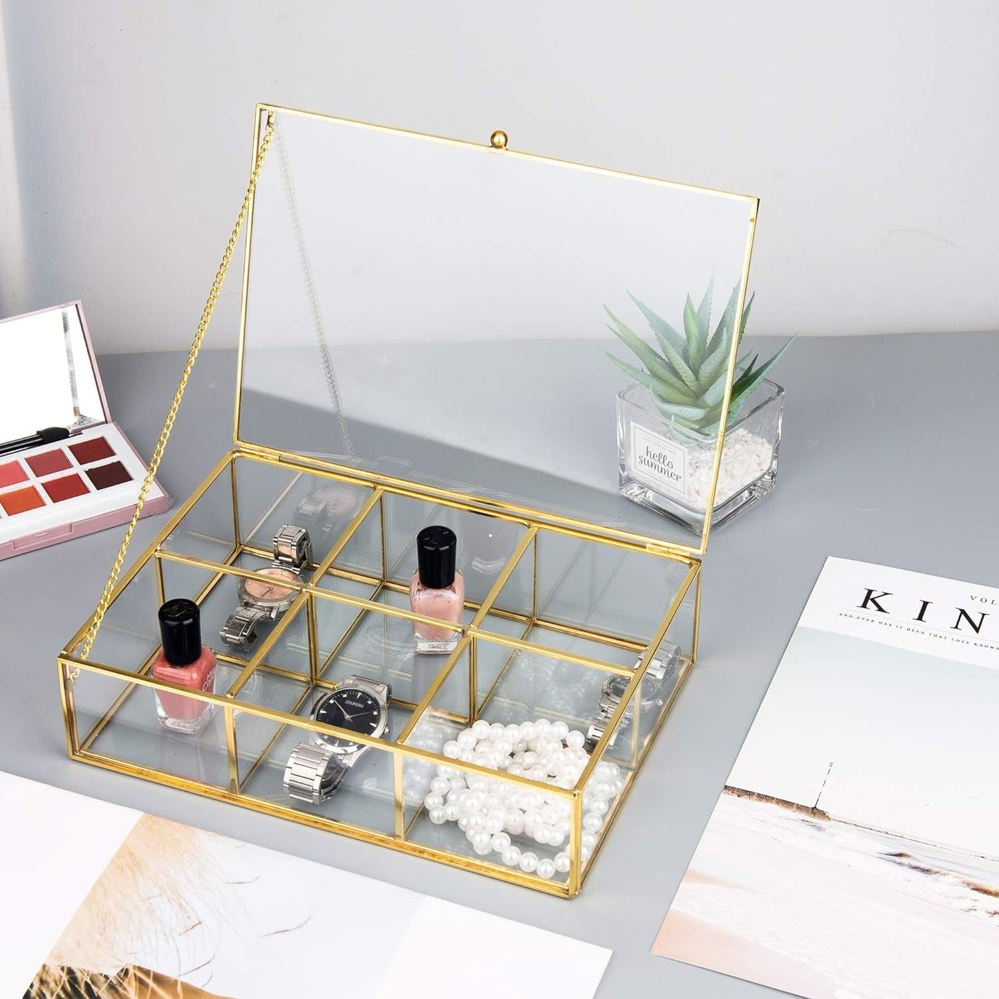 Jewelry Trinket Box with an open lid and divided compartments organizing nail polish, watches, and accessories