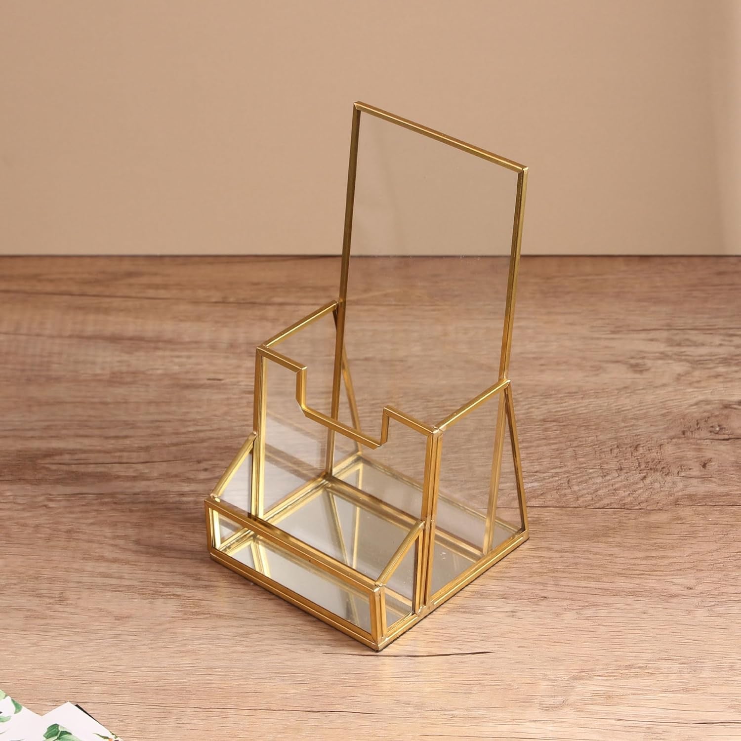 Brochure Holder with a polished glass frame and angled trifold structure displayed in a clean tabletop setting