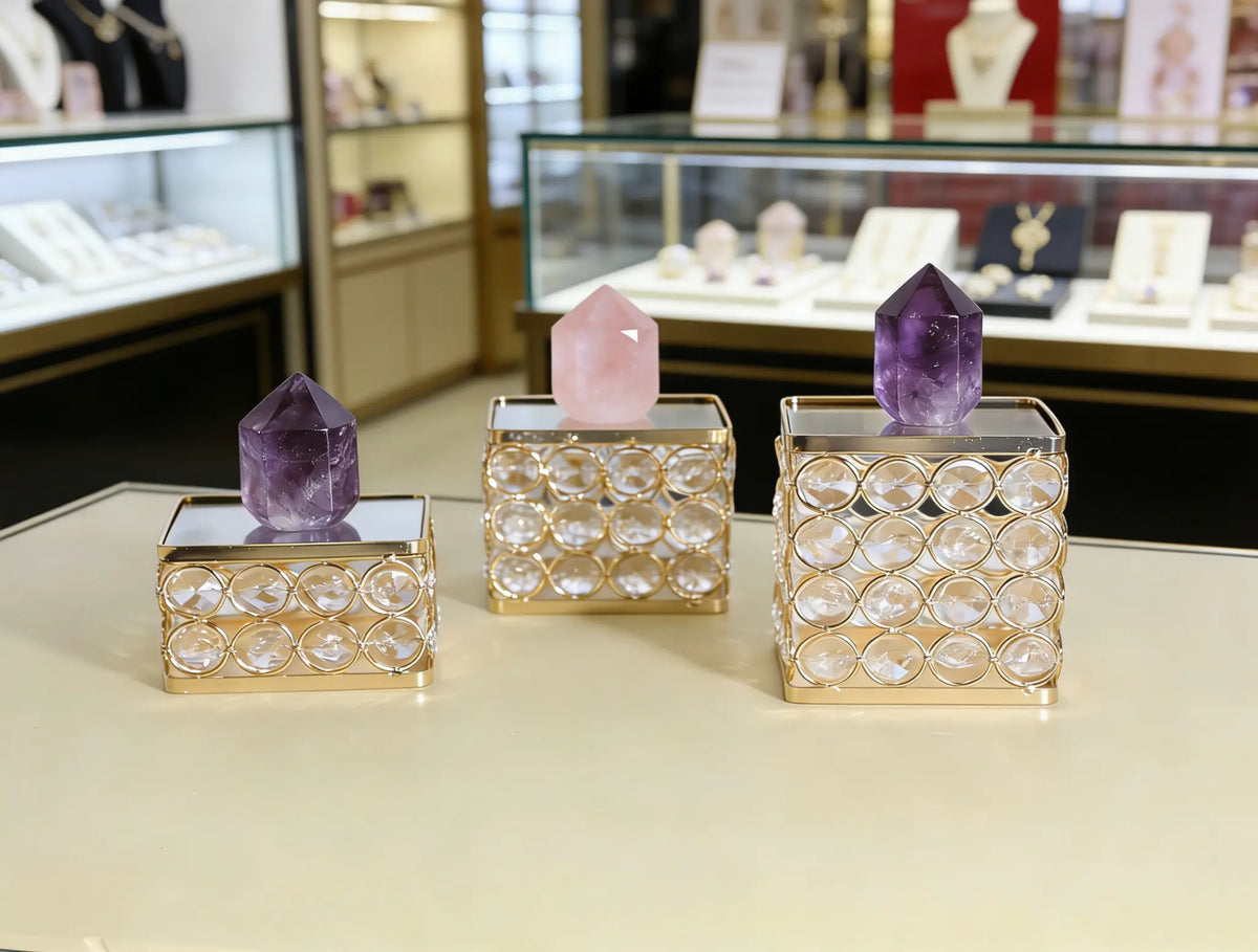 Crystal Display Pedestal showcasing crystal pieces with a refined mirrored surface and sparkling bead accents