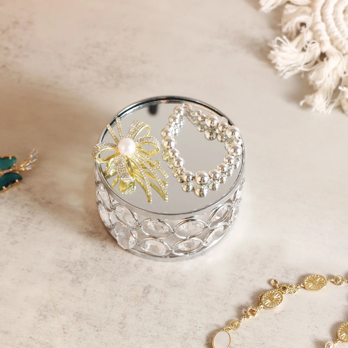 Elegant Silver Display Platform showcasing small jewelry with sparkling crystal details for a refined presentation