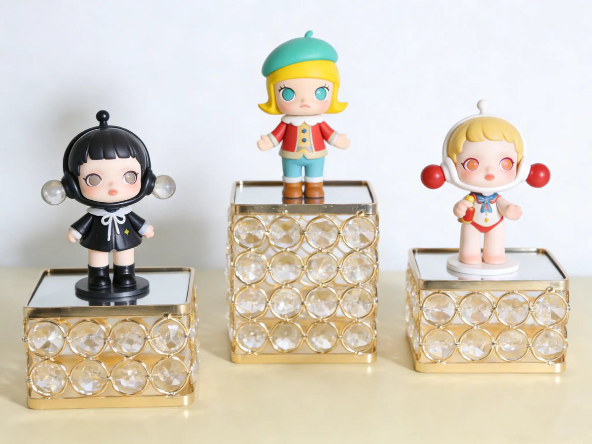 Gold Crystal Display Pedestal creating an elevated figurine display with a sparkling mirrored surface