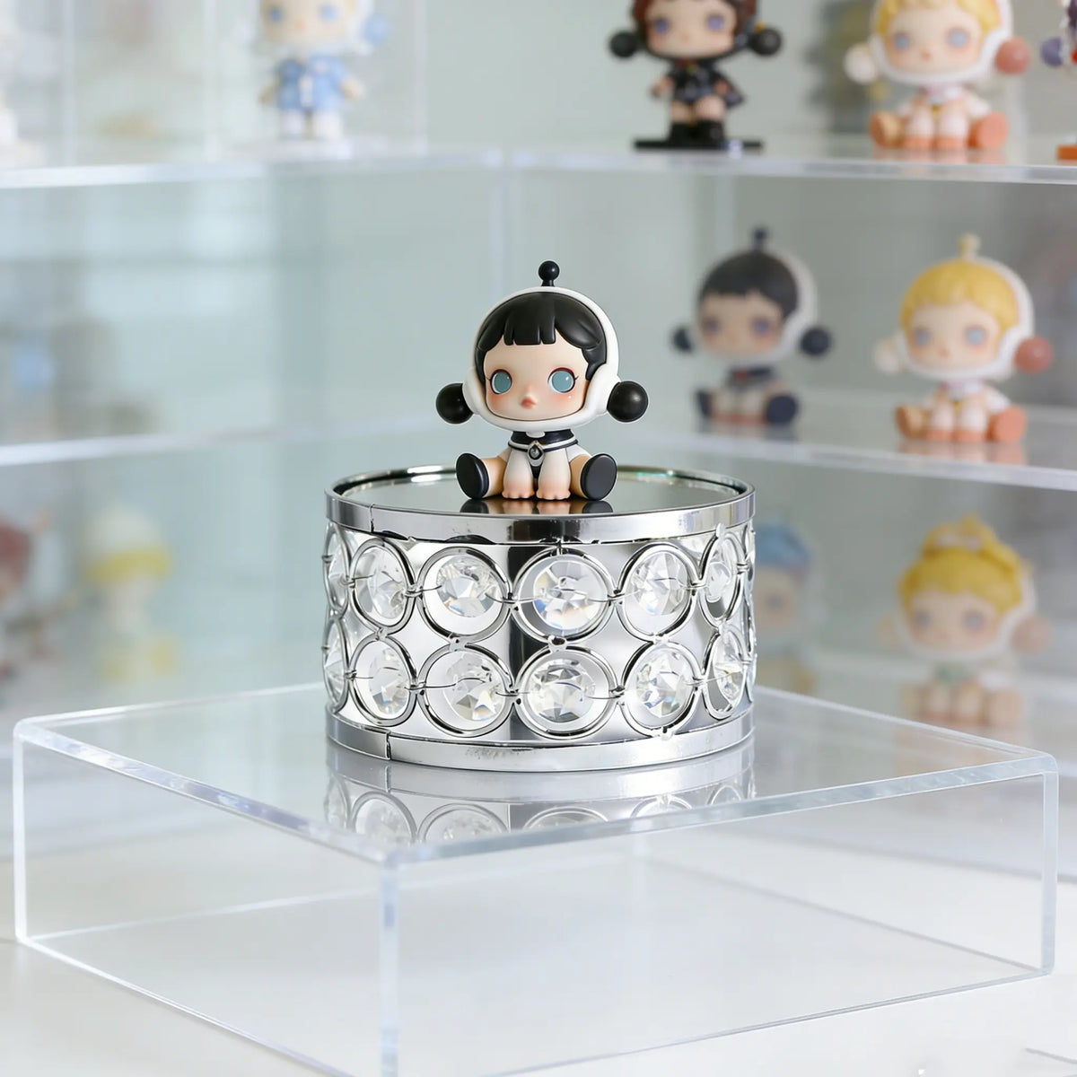 Silver Display Platform showcasing collectible figures with sparkling crystal details for an attractive display