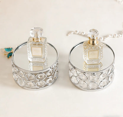 Elegant Silver Display Platform showcasing two perfume bottles with sparkling crystal details for a luxurious presentation