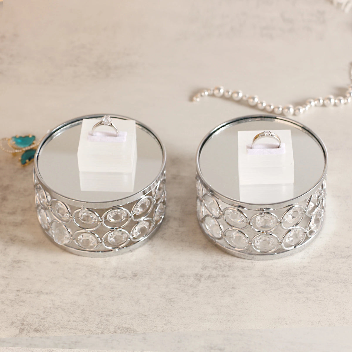 Elegant Silver Display Platform showcasing a ring with sparkling crystal details for a delicate jewelry presentation