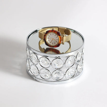 Elegant Silver Display Platform showcasing a watch on its crystal surface with a refined decorative presentation