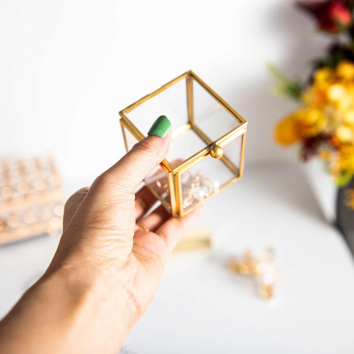 Small Gold Glass Jewelry Box held in hand showcasing its compact size and elegant design