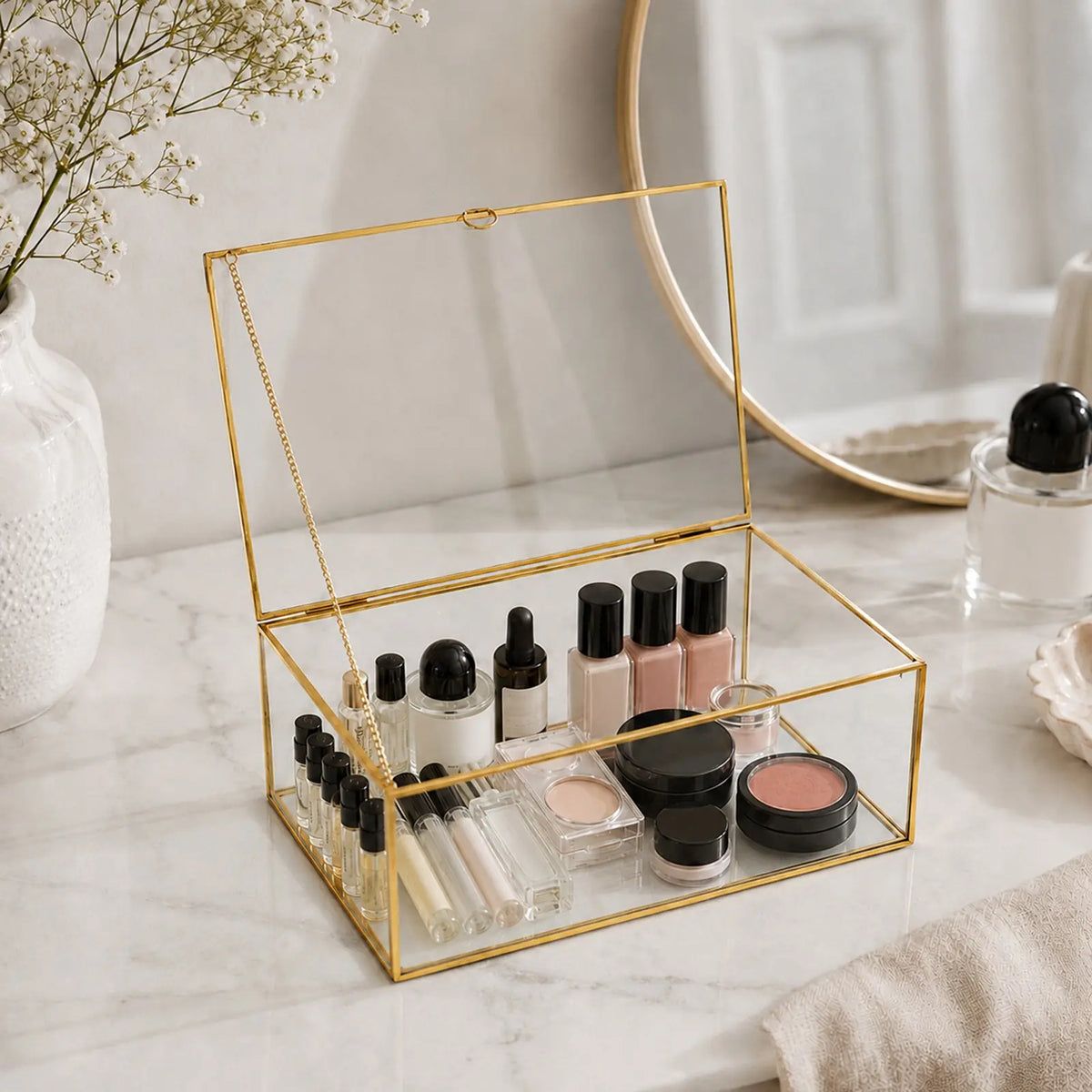 Gold Glass Keepsake Box displaying cosmetics on a tabletop with an elegant decorative style