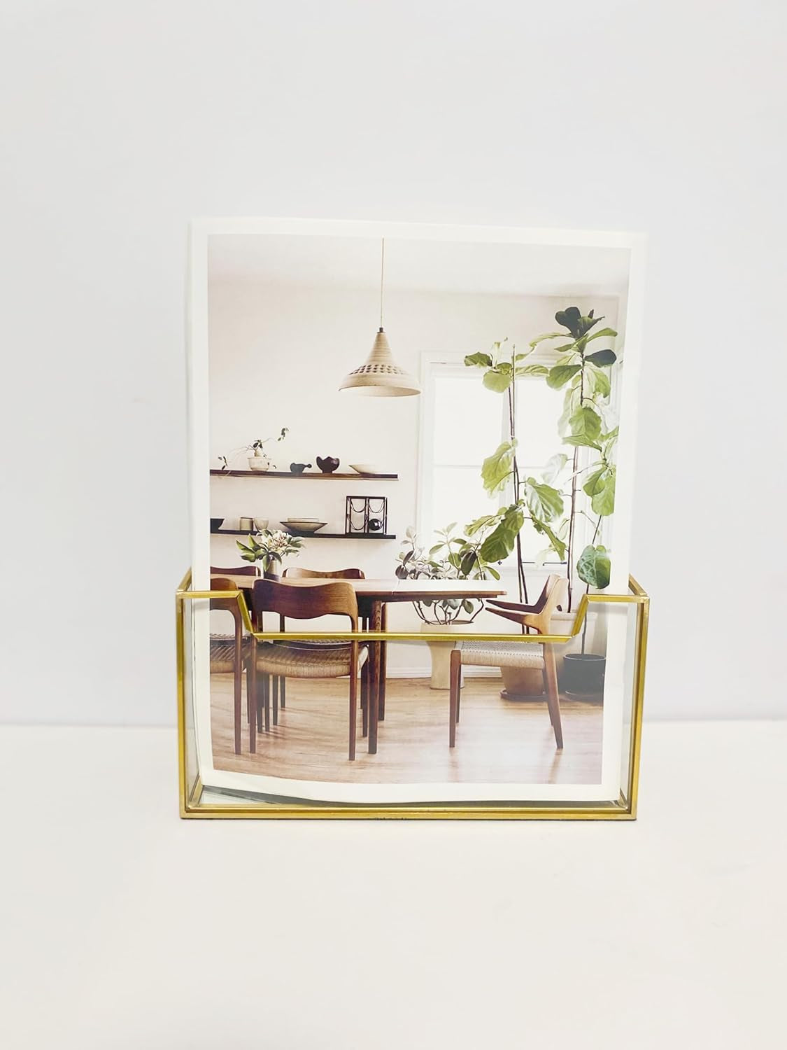 Glass Brochure Holder with sleek gold frame displaying photos on a tabletop for elegant decor and display