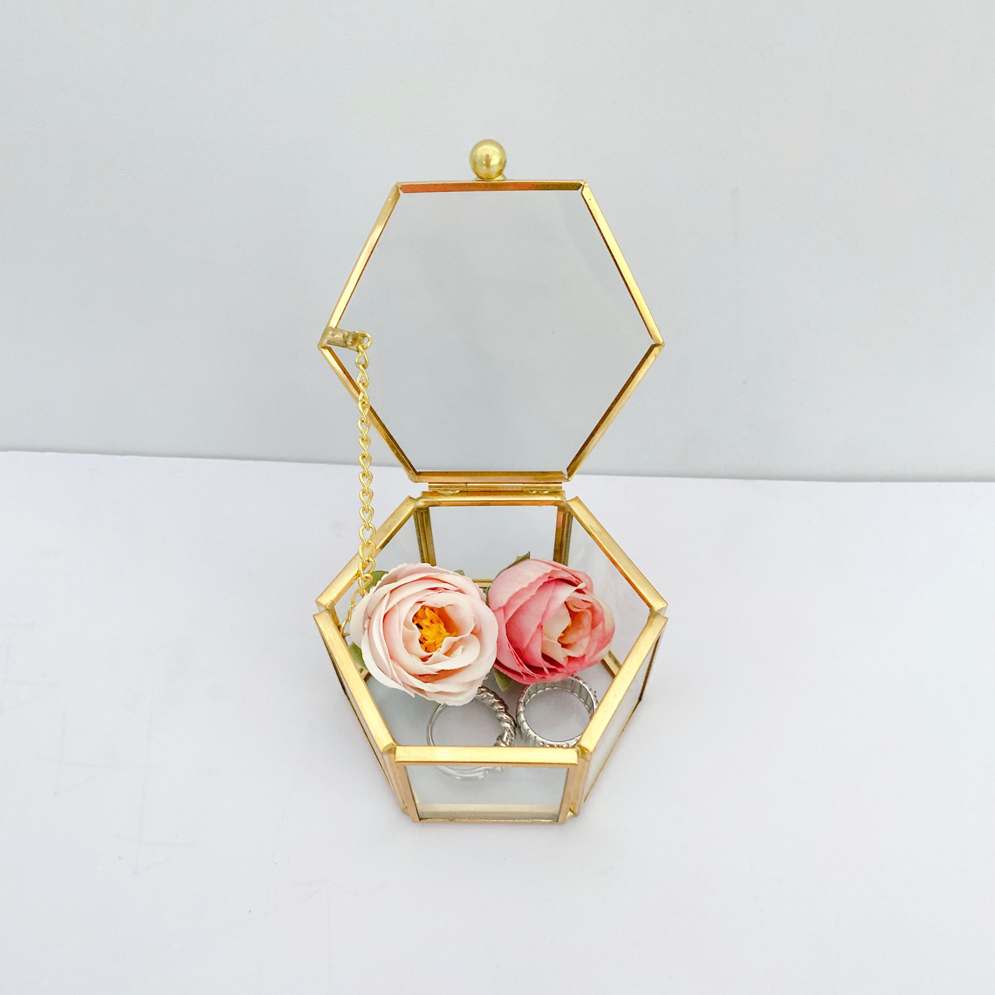 Gold Glass Jewelry Box displaying accessories and decor on a tabletop with a refined style