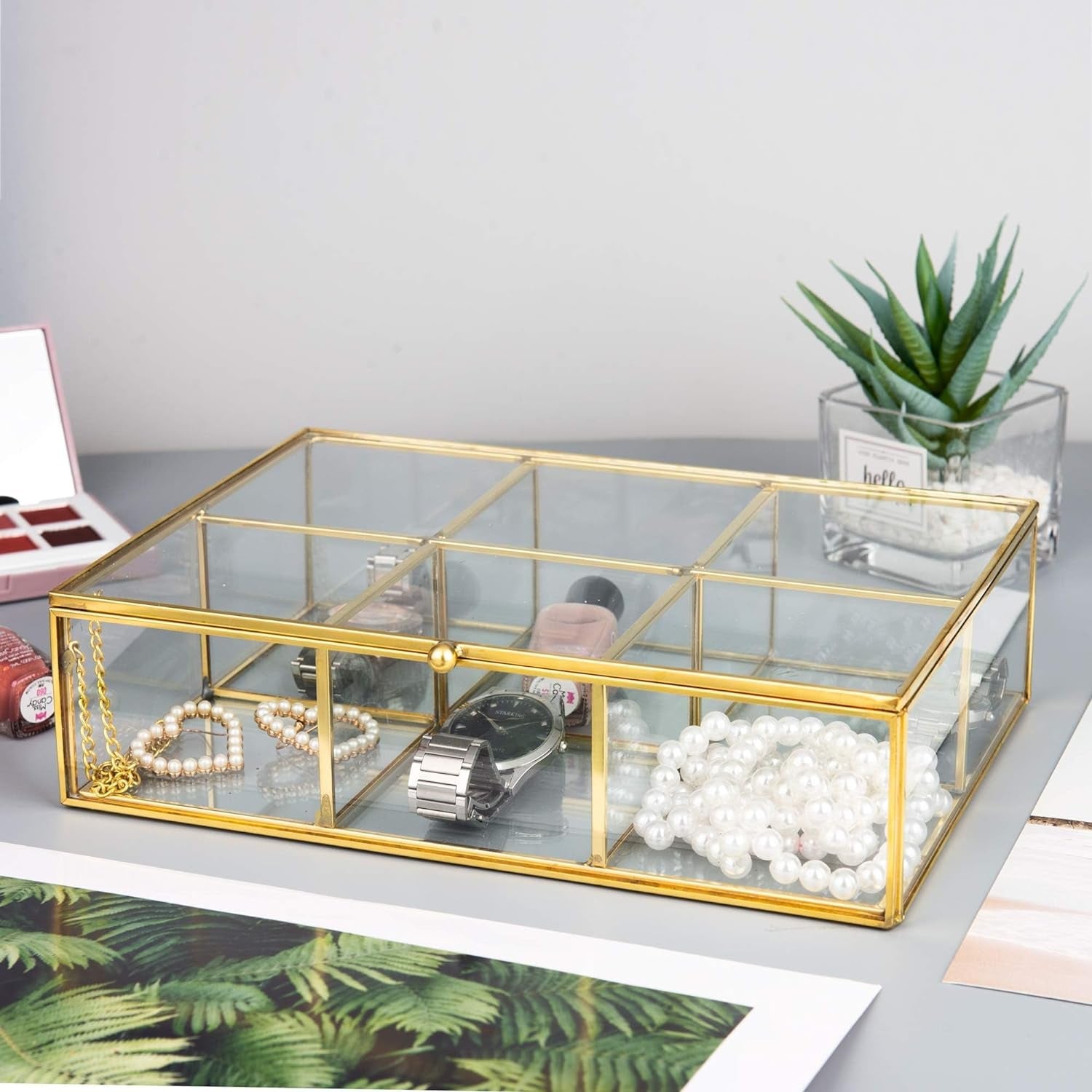 Gold Glass Jewelry Trinket Box with accessories creating a neat and stylish tabletop organization setup