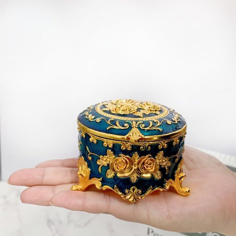 Compact Blue Jewelry Box held in hand showcasing its small size and elegant engraved design