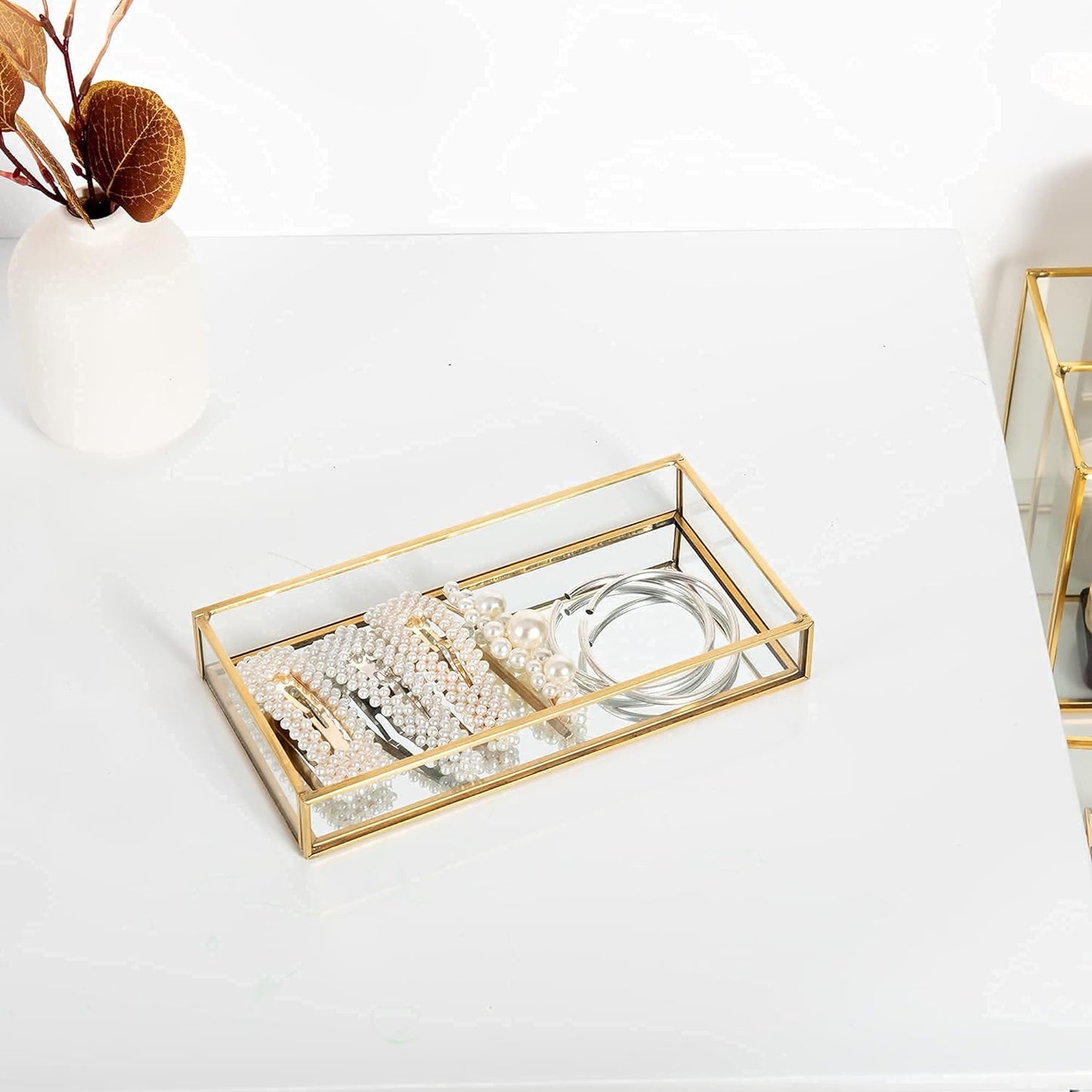 Glass Organizer Tray displaying jewelry with a mirrored surface enhancing accessory shine