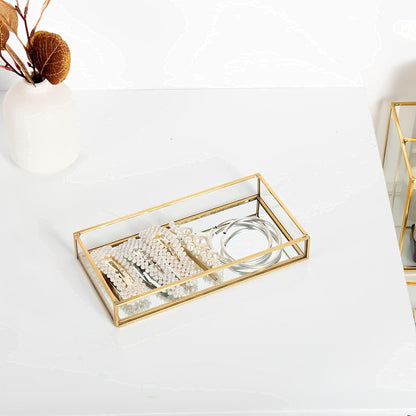 Glass Organizer Tray displaying jewelry with a mirrored surface enhancing accessory shine