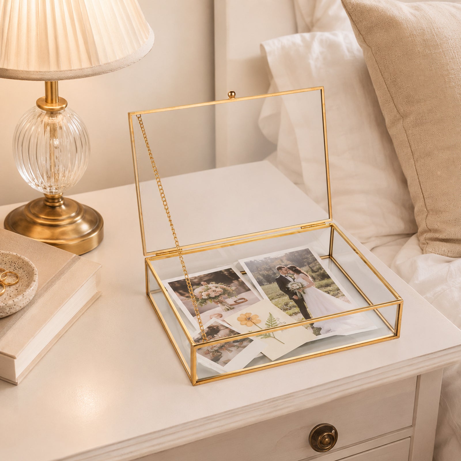 Gold Clear Glass Display Box holding photos on a nightstand for preserving meaningful memories