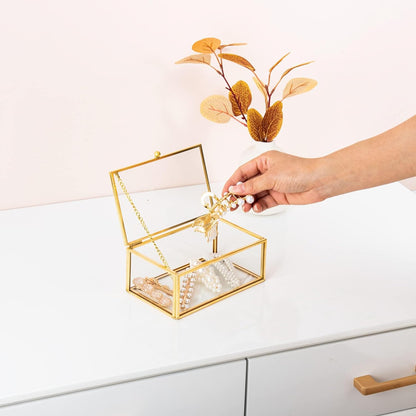 Gold Glass Organizer Box showing a hand retrieving jewelry for convenient access
