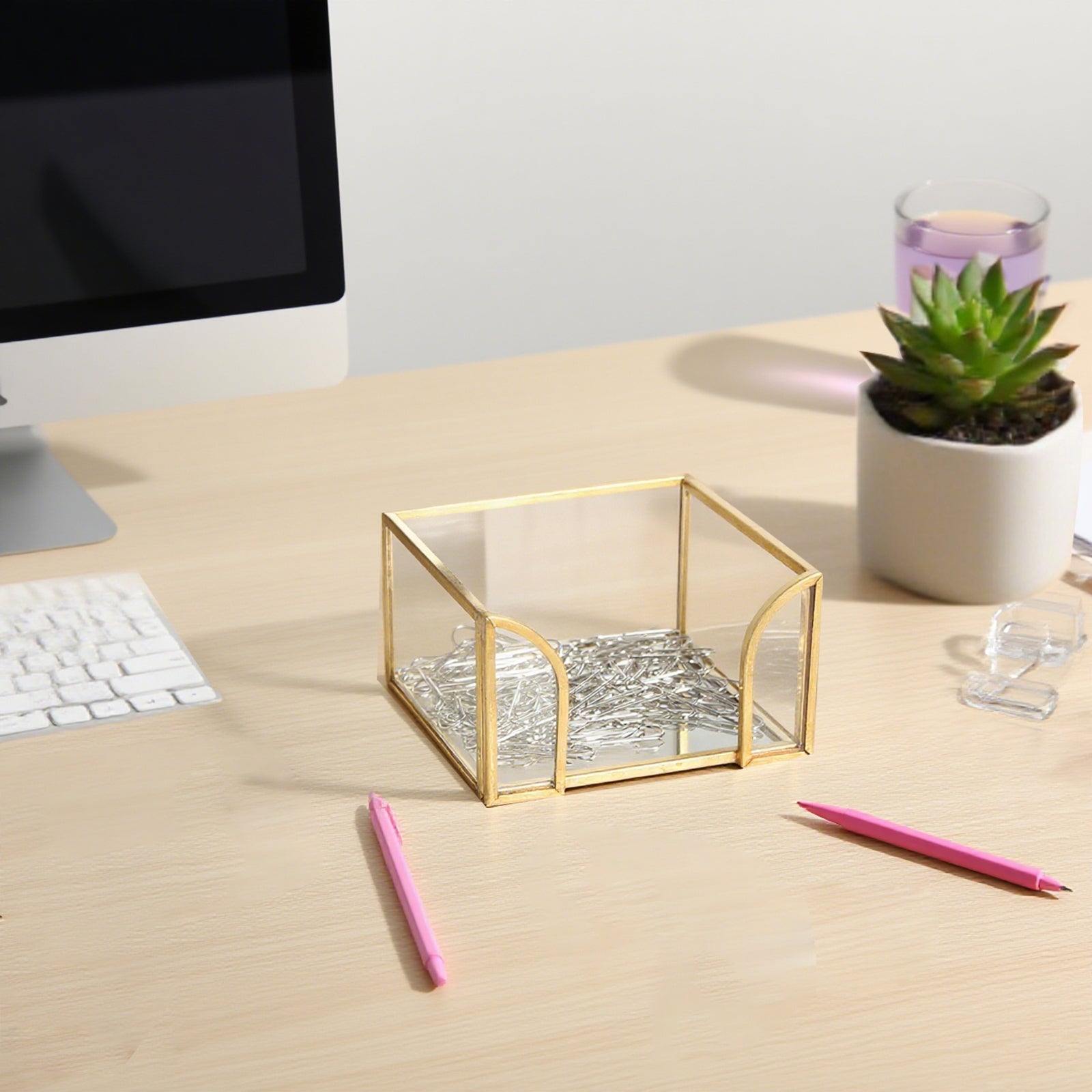 Glass Sticky Note Holder with paper clips on a desktop, organizing notes, clips and small office supplies
