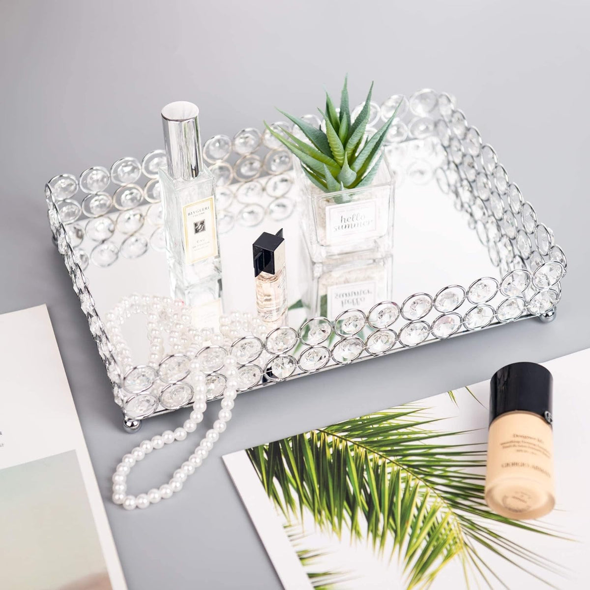 Crystal Vanity Tray with jewelry and a small plant displayed on top, adding a natural touch to home decor