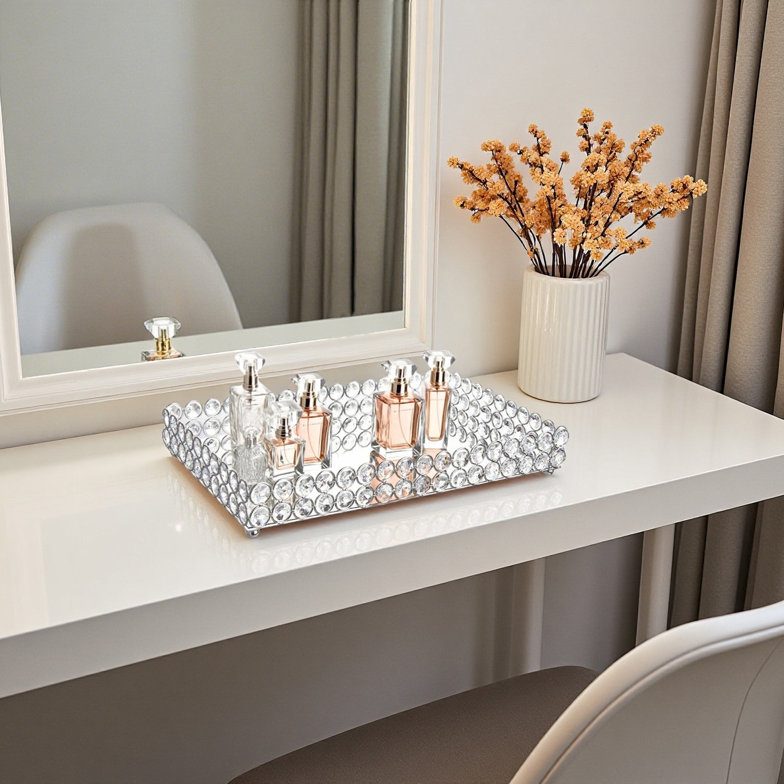 Stylish Crystal Vanity Tray holding perfume bottles on a dresser, creating an organized and elegant beauty display